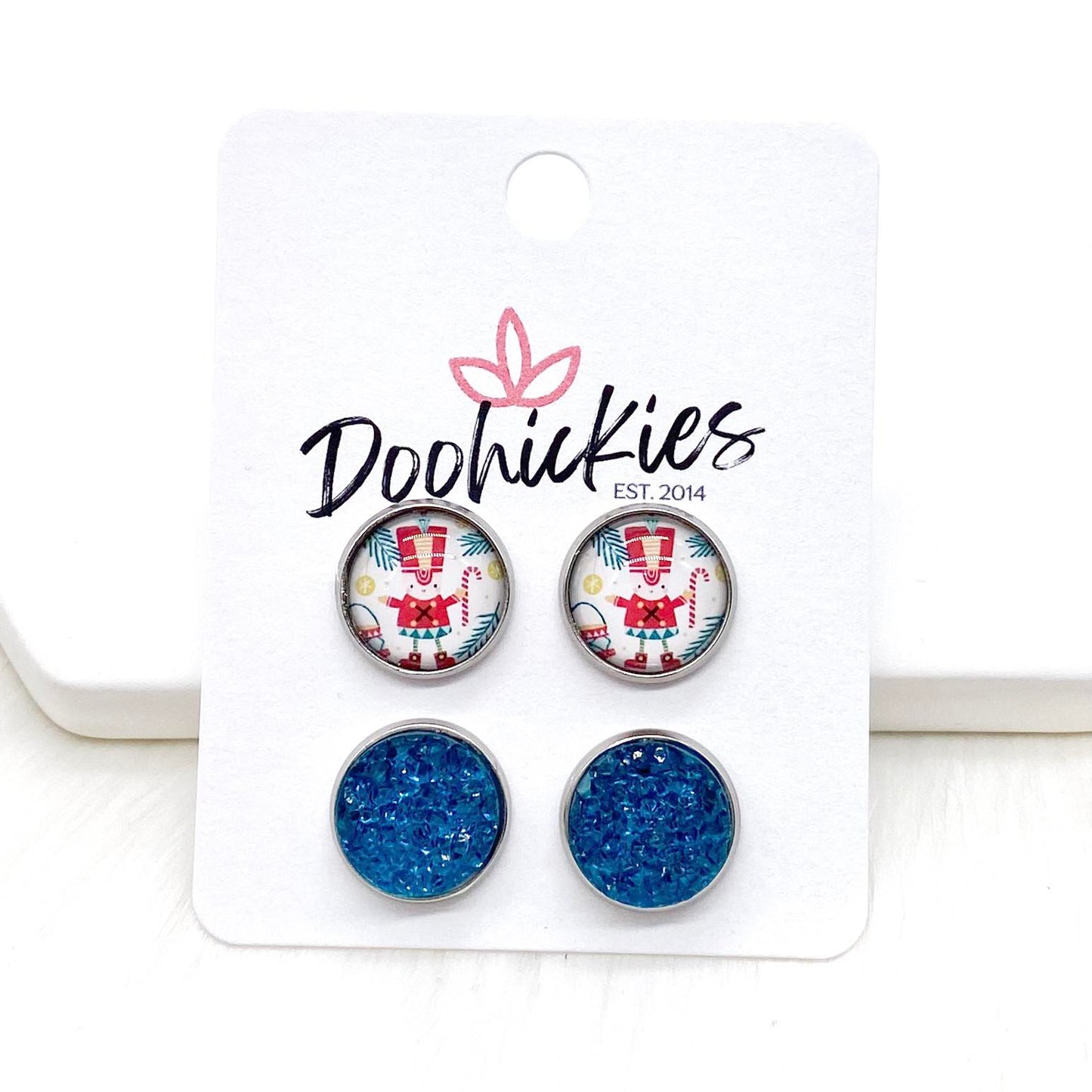 12mm Nutcracker & Teal Sparkles in Stainless Steel Settings -Christmas Studs by Doohickies Wholesale