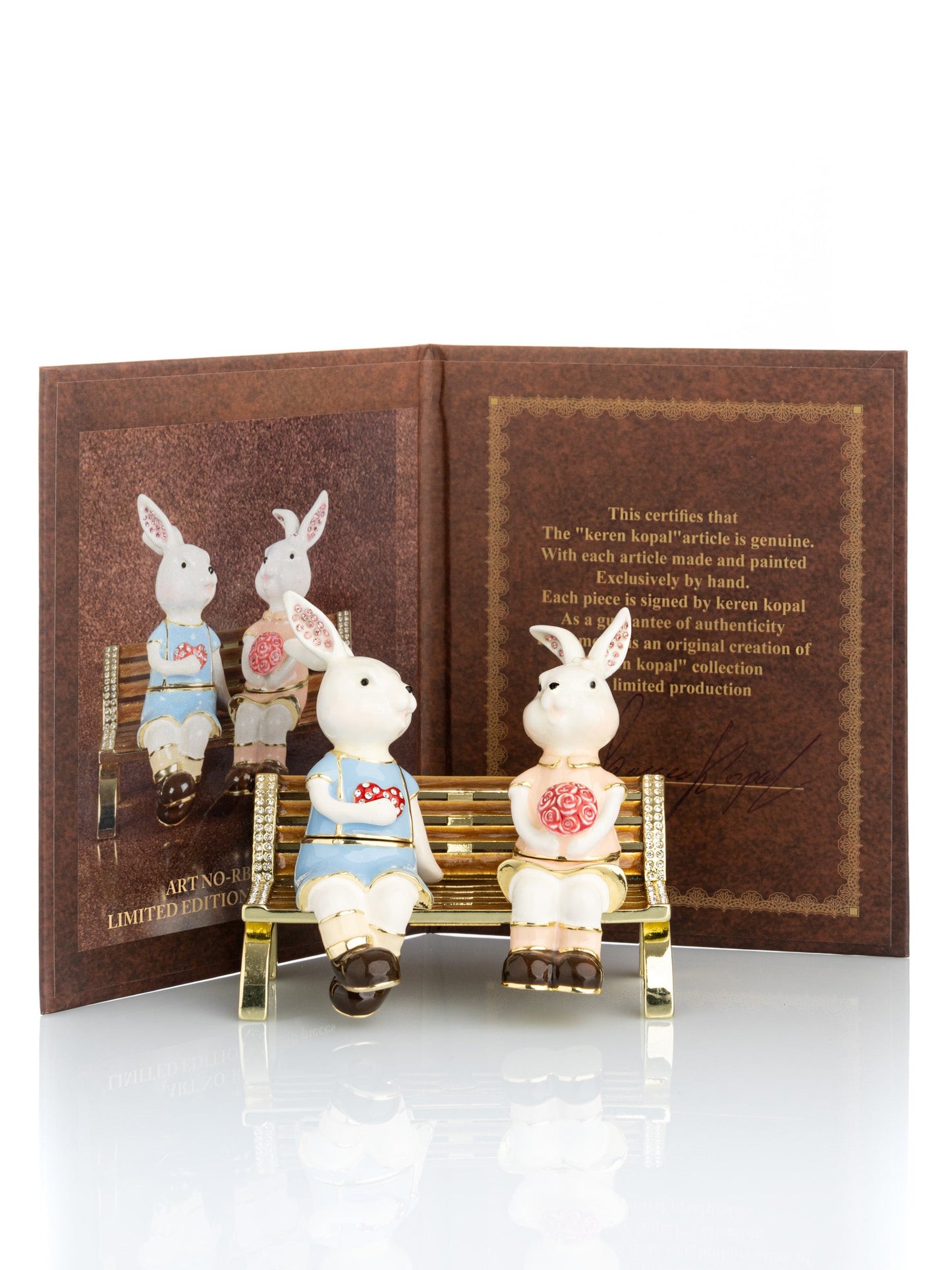 2 bunnies in love sitting on a bench, valentine flowers and chocolates by Keren Kopal