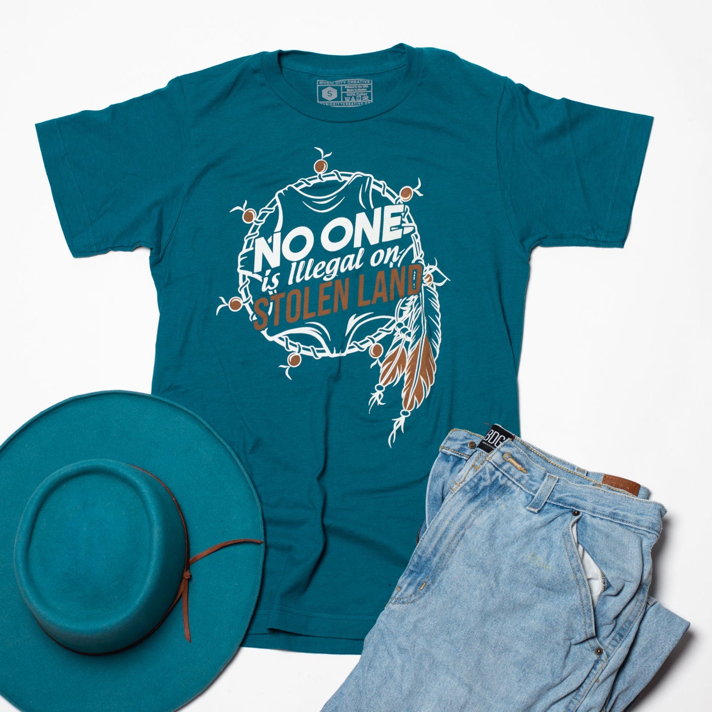 No One Is Illegal Tee by Music City Creative