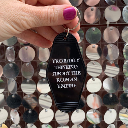 Probably Thinking About the Roman Empire Motel Style Keychain in Black by The Bullish Store