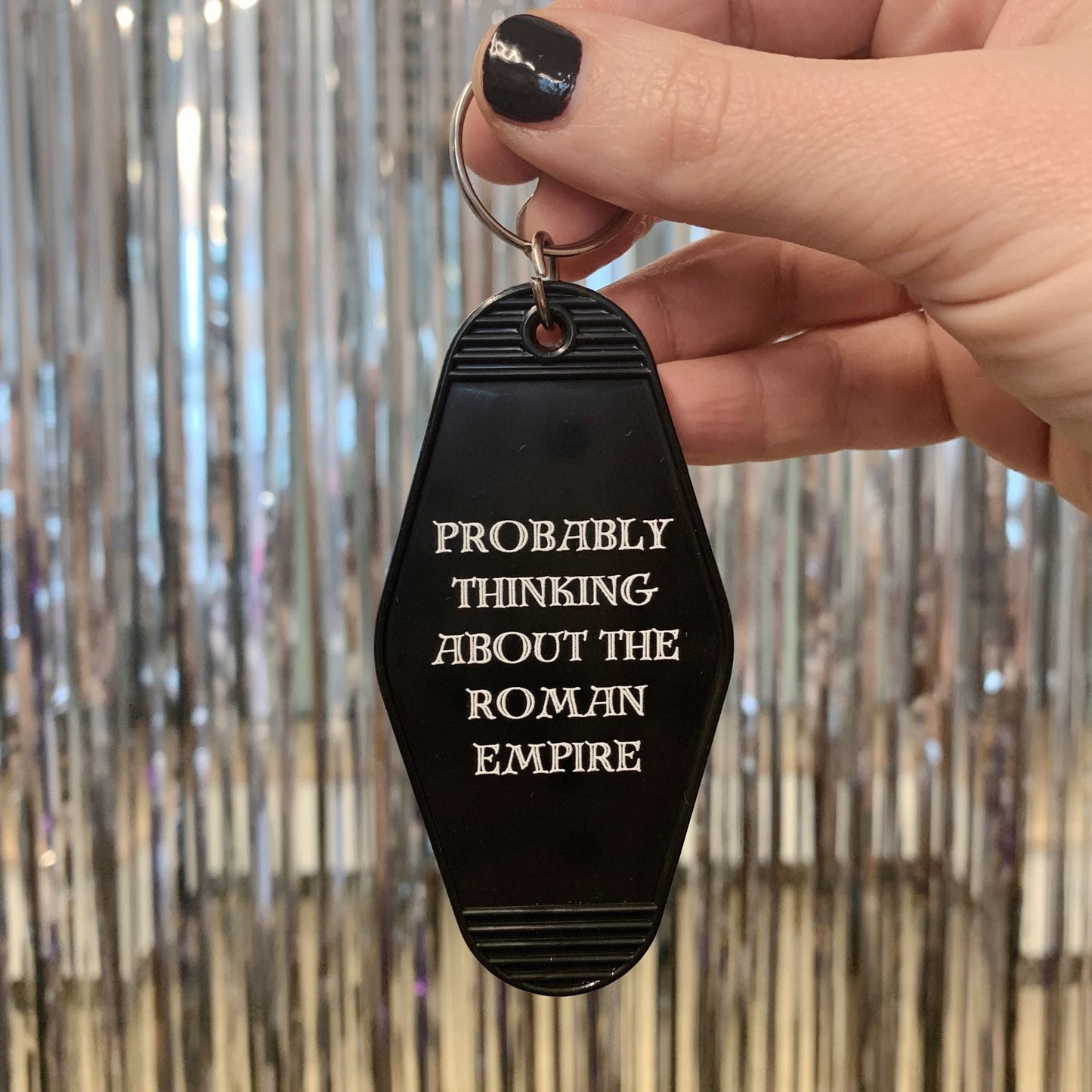 Probably Thinking About the Roman Empire Motel Style Keychain in Black by The Bullish Store