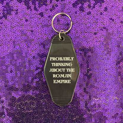 Probably Thinking About the Roman Empire Motel Style Keychain in Black by The Bullish Store