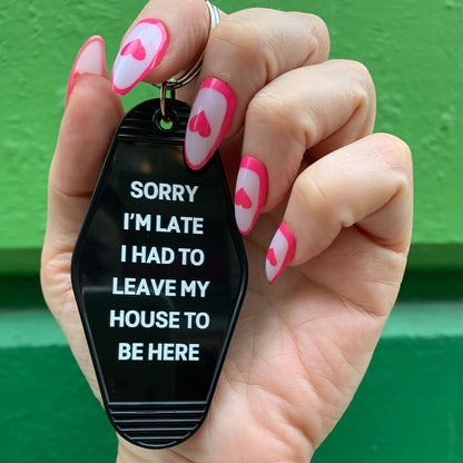 Sorry I’m Late I Had to Leave My House Motel Style Keychain in Black by The Bullish Store