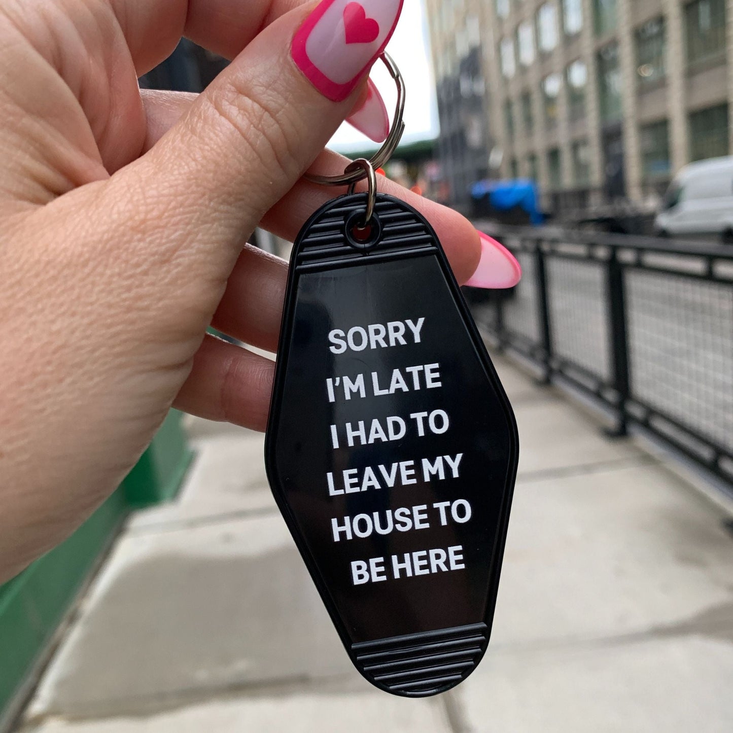 Sorry I’m Late I Had to Leave My House Motel Style Keychain in Black by The Bullish Store