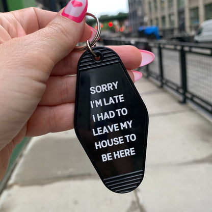 Sorry I’m Late I Had to Leave My House Motel Style Keychain in Black by The Bullish Store