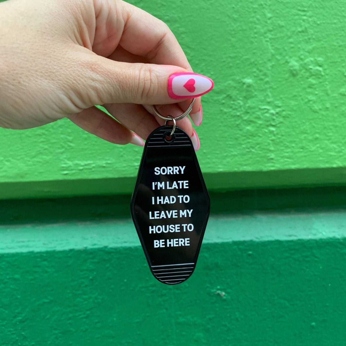 Sorry I’m Late I Had to Leave My House Motel Style Keychain in Black by The Bullish Store