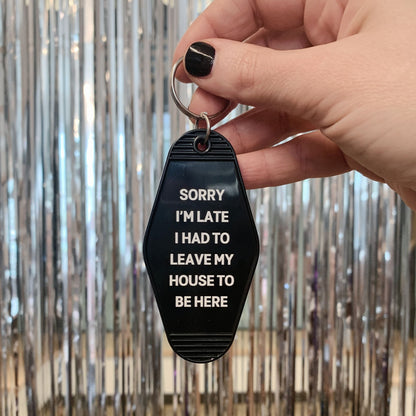 Sorry I’m Late I Had to Leave My House Motel Style Keychain in Black by The Bullish Store