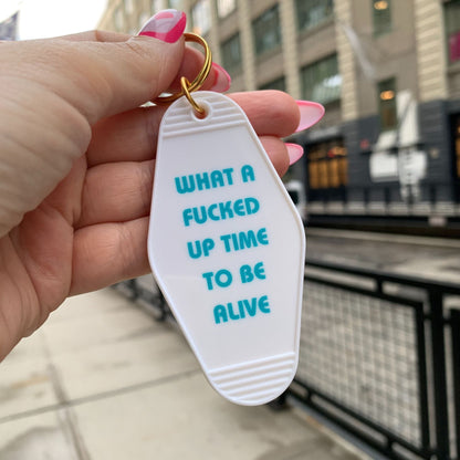 What a Fucked Up Time to Be Alive Motel Style Keychain in White by The Bullish Store