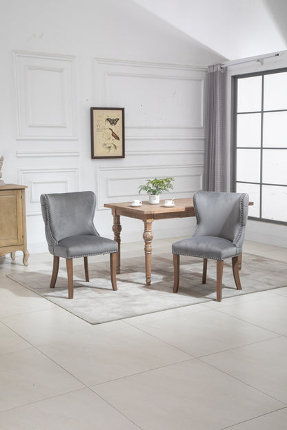 Set of 2 upholstered wing-back dining chair with backstitching nailhead trim and solid wood legs