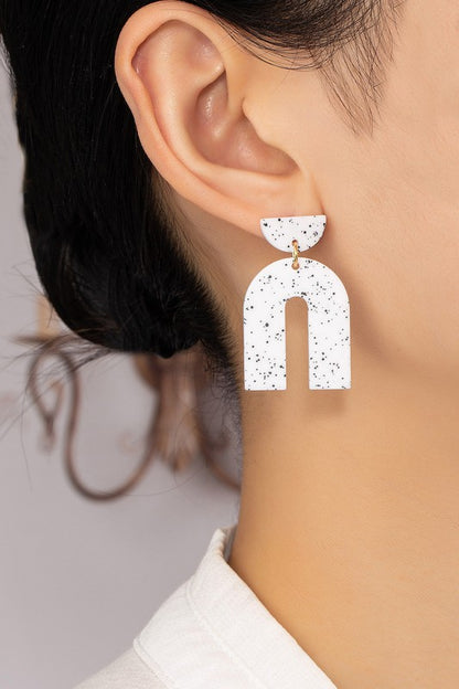 arch drop earrings with black speckles