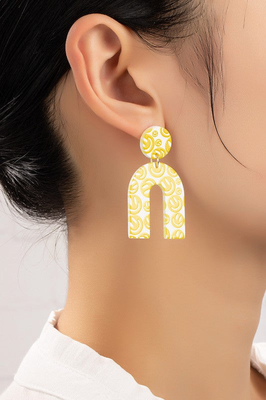 Dangling smiley face arch drop earrings