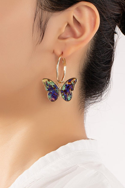 Acetate butterfly dangling on a hoop earrings