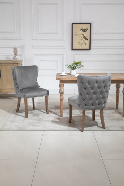 Set of 2 upholstered wing-back dining chair with backstitching nailhead trim and solid wood legs