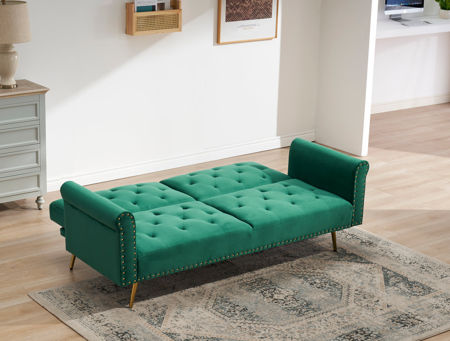 Green velvet nail head sofa bed with throw pillow and midfoot