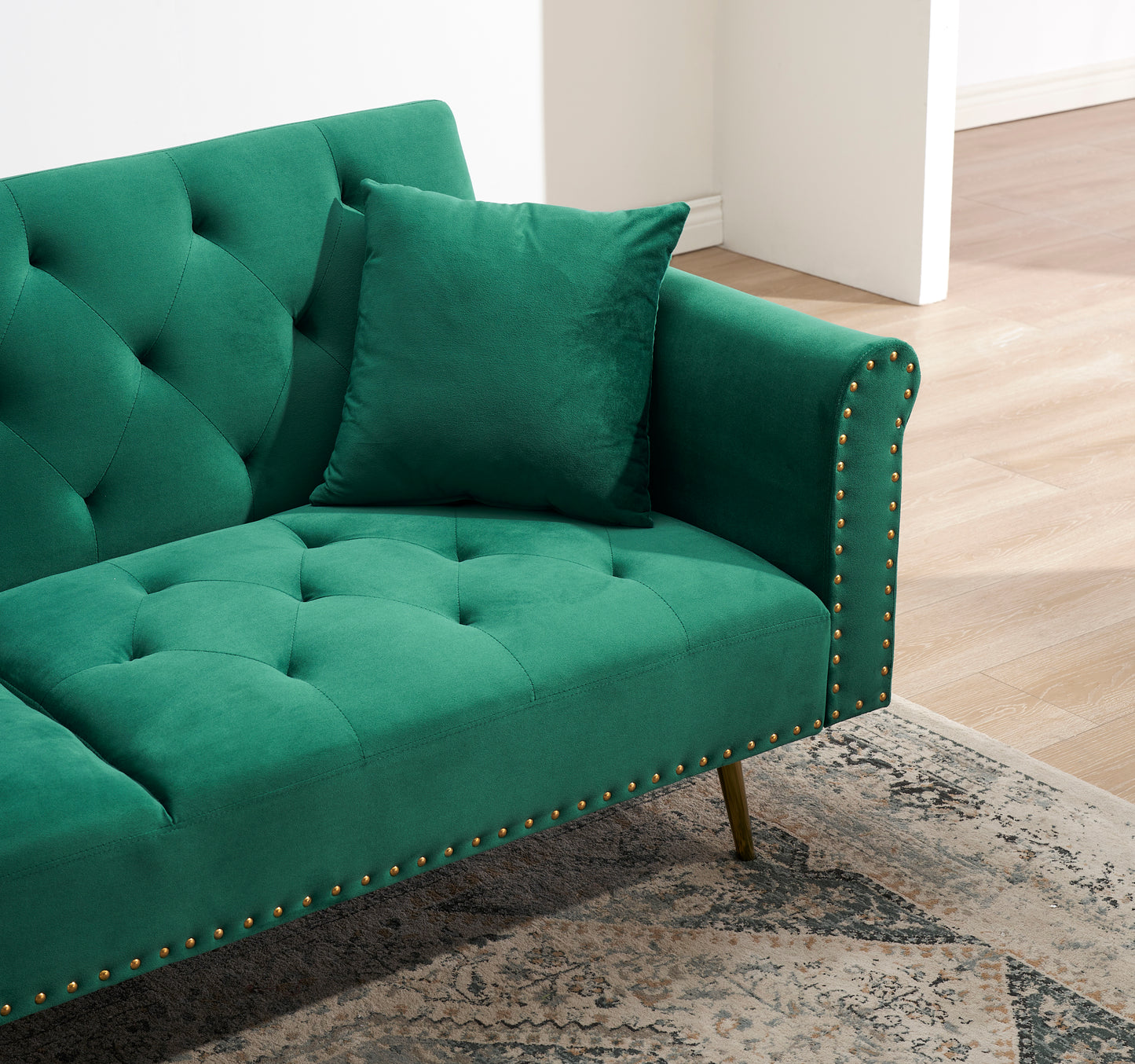 Green velvet nail head sofa bed with throw pillow and midfoot