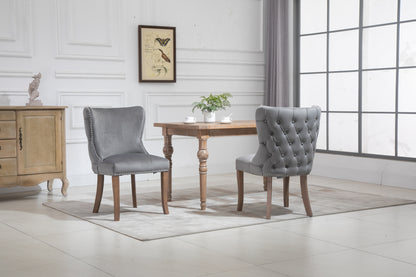 Set of 2 upholstered wing-back dining chair with backstitching nailhead trim and solid wood legs