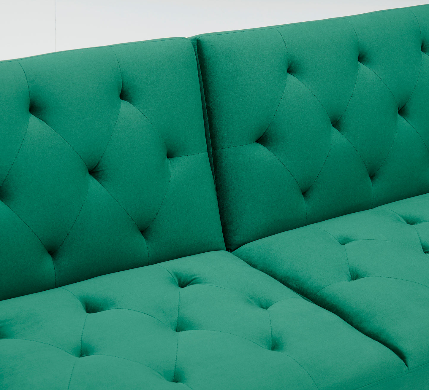 Green velvet nail head sofa bed with throw pillow and midfoot