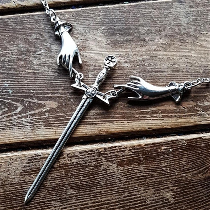 Hand With Sword Necklace by White Market