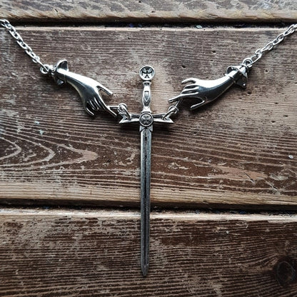 Hand With Sword Necklace by White Market