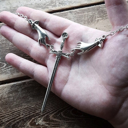 Hand With Sword Necklace by White Market