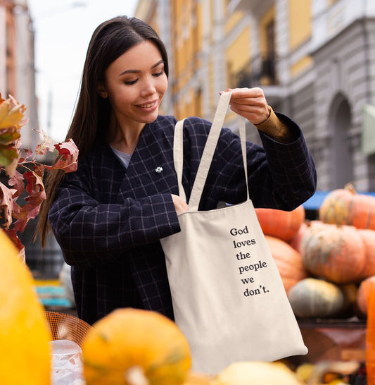 God Loves The People We Don't | Tote Bag by The Happy Givers
